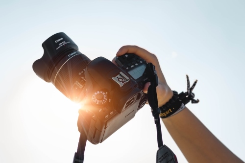 Hand holding camera up to sun 